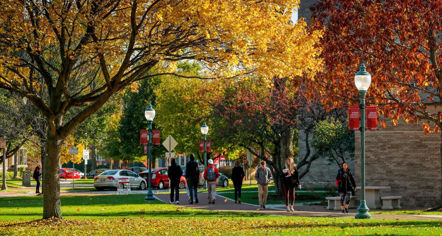 Students walking on campus in the fall